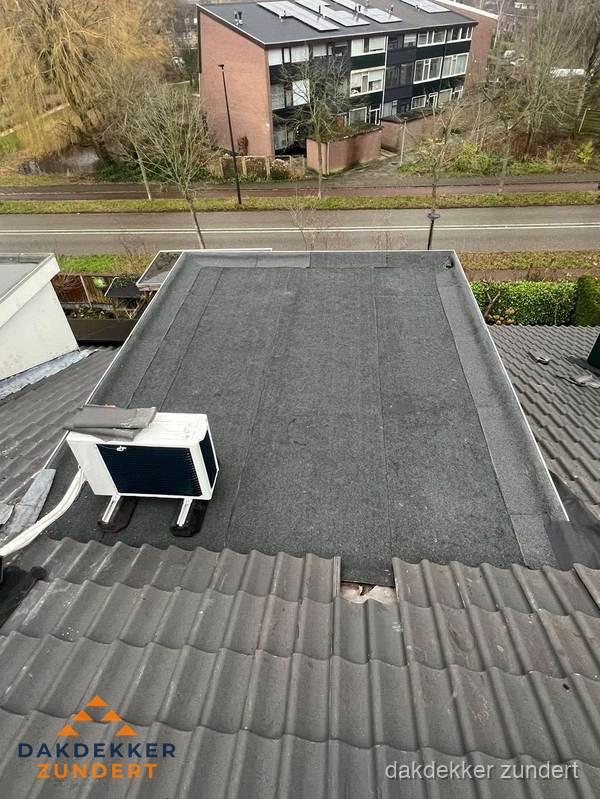 Plat dak inspectie met bitumen bedekking naast schuin pannendak in Zundert Plat dak inspectie met bitumen bedekking naast schuin pannendak in Zundert